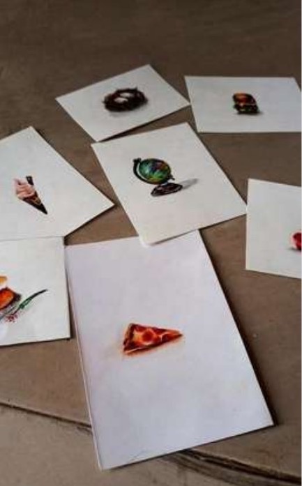Several coin-sized miniature paintings scattered across a table