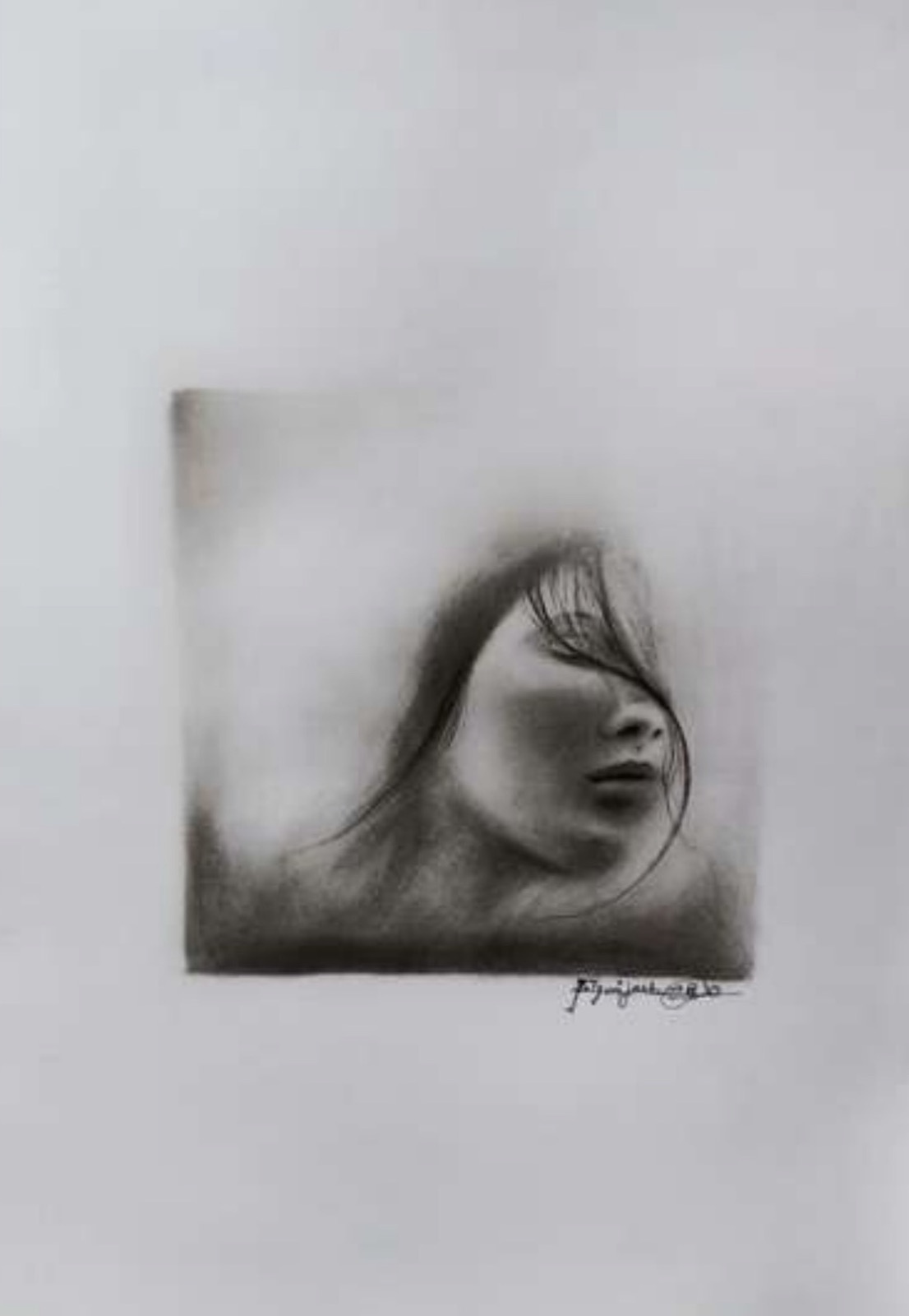 Charcoal portrait of a woman in profile with closed eyes and windswept hair, rendered inside a soft smudged square with the artist's handwritten signature beneath.